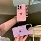 Pink and purple phone cases with crocodile texture held by a person.