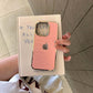 Pink phone case with gold accents held over a book titled 'If You See All of Me'.