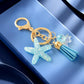 Keychain with starfish charm and tassel on a blue background